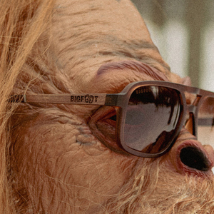 Glacier Sunglasses Bigfoot Edition worn by costumed model showing BIGFOOT engraved wood temple detail