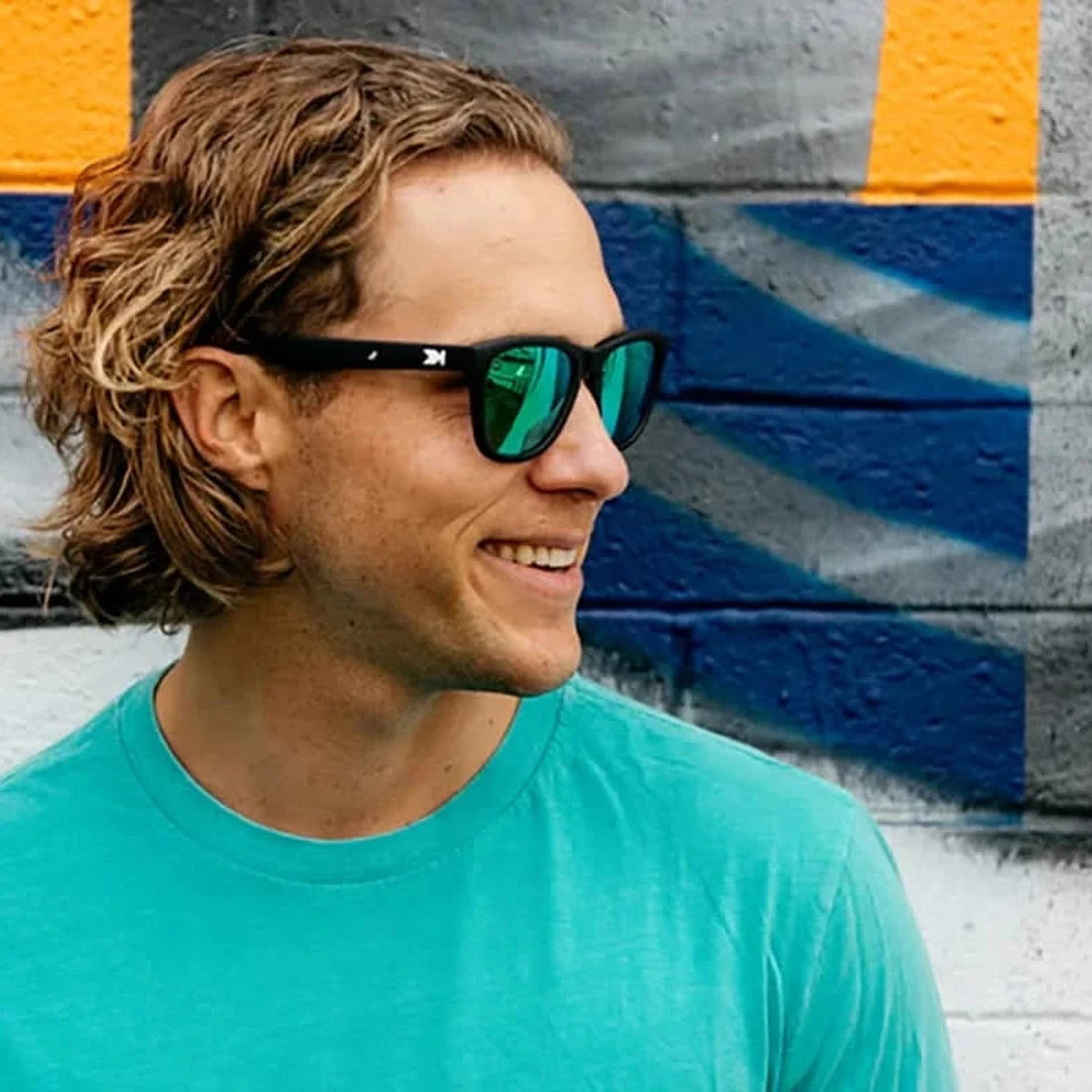 Man wearing Premiums sunglasses in black with green moonshine lenses outdoors, The Simple Man