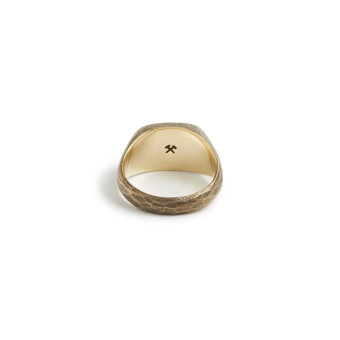 Solid brass signet ring showing interior crossed-hammers hallmark and hand-filed texture – Studebaker Metals at The Simple Man