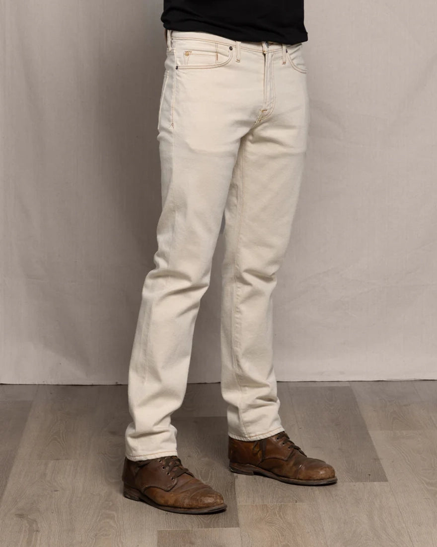 Ace Rivington Brodie Taper Jean Ecru Rinse side view on model with brown leather boots — men's tapered fit ecru denim