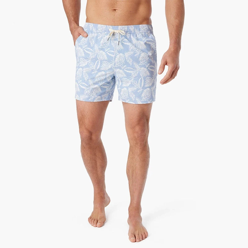 Model Wearing Fair Harbor Bungalow Trunk in sky blue leaves pattern, front view