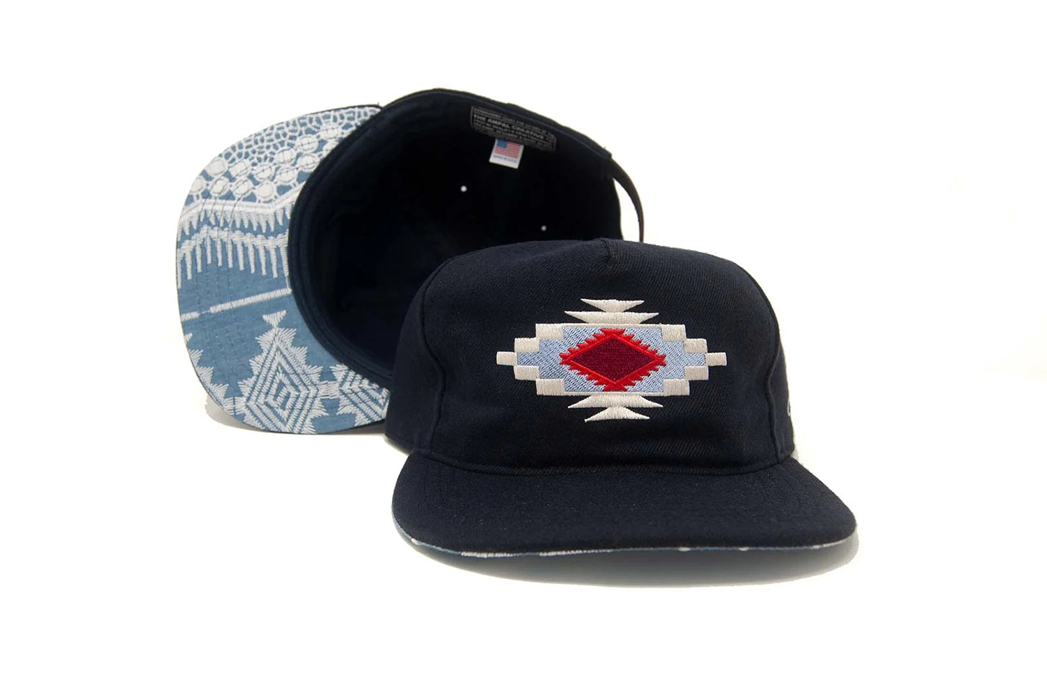 Chimayo Wool Strapback Hat displayed with front embroidery and visible patterned underbrim inspired by Southwest textiles.