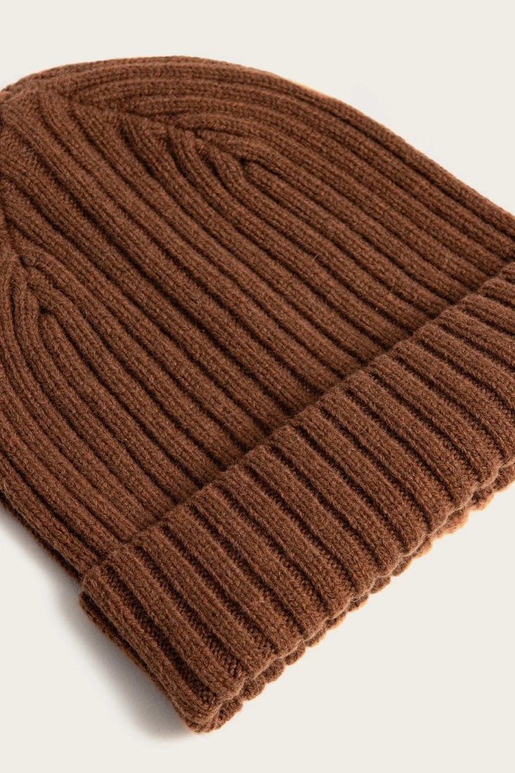 Close-up of warm ochre chunky ribbed merino wool beanie showing textured knit cuff detail from The Simple Man