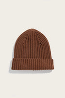 Flat lay of warm ochre ribbed merino wool beanie with folded cuff — sustainable men’s beanie by The Simple Man