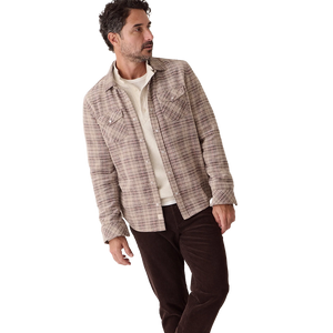 Man in the Clark brown plaid corduroy shirt open over a cream henley and dark brown cords, three-quarter view