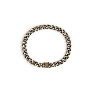 Classic brass chain bracelet with work patina finish and hallmark clasp displayed on white background, Studebaker Metals.