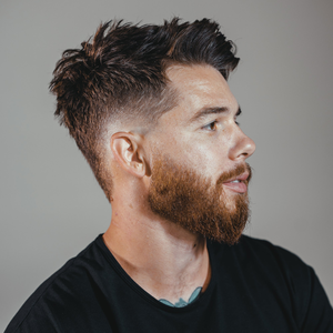 Bearded man in side profile with a textured, tousled top, styled with Claymation