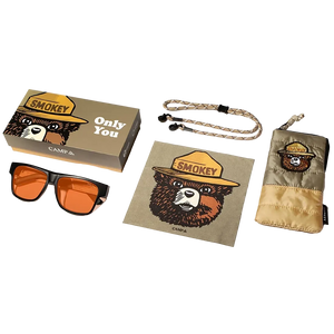 Collection of Smokey Bear-themed items including sunglasses, pouch, and lanyard on a white background.