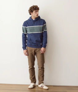 Man wearing Mood Indigo Colorblock fleece hoodie with brown pants, full body front view - The Simple Man