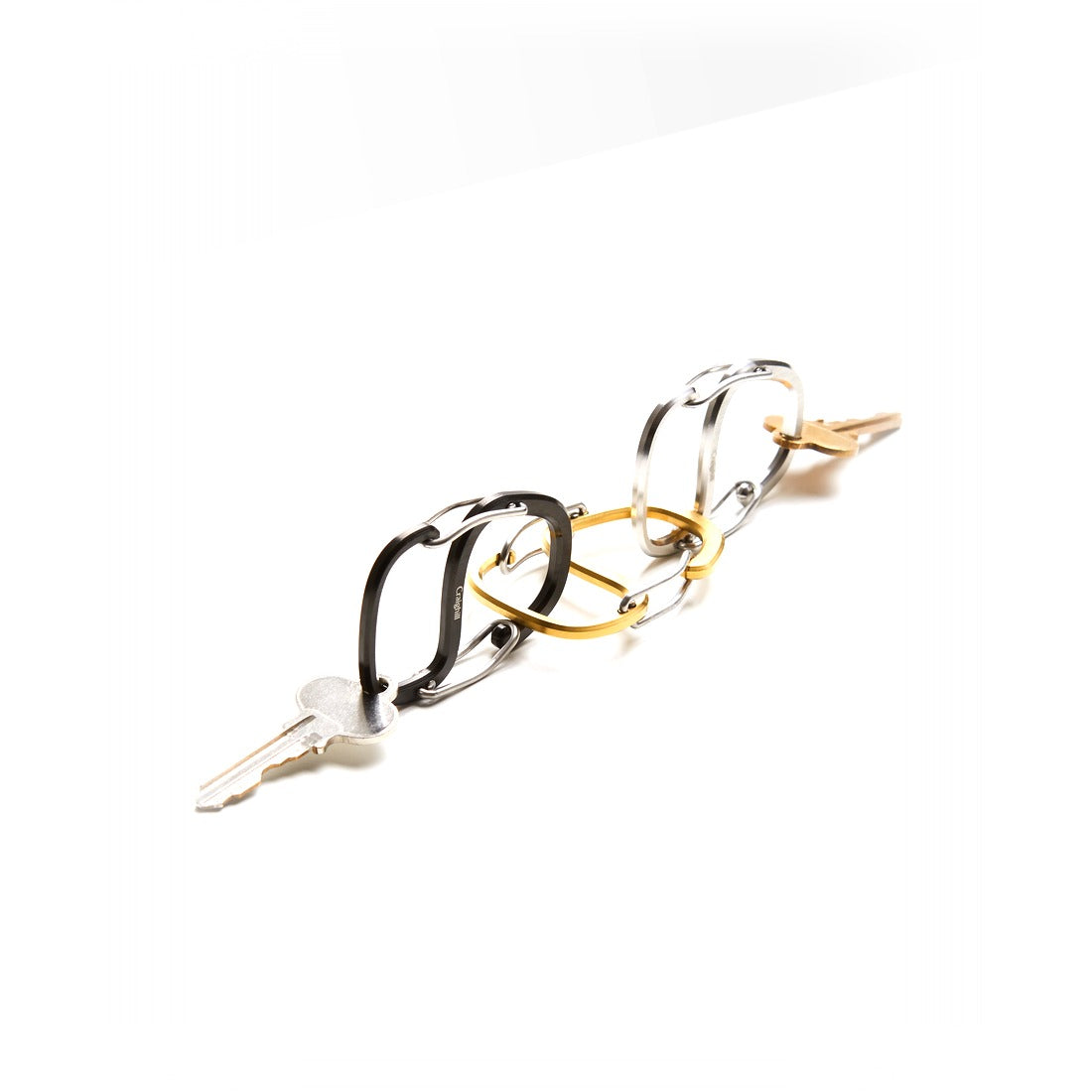 Coachwhip Carabiners in black, stainless and brass linked together with a key - The Simple Man