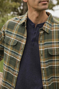 Close-up of The Cole Slim Fit Shirt in Mountain Green plaid worn over navy henley, showcasing soft brushed cotton fabric and dual chest pockets