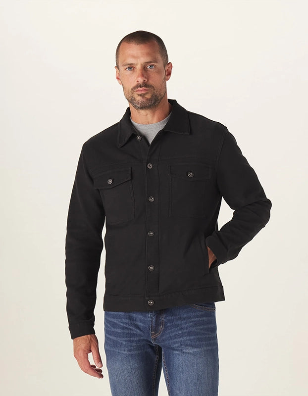 Model Wearing he Normal Brand Comfort Terry Trucker Jacket in black, front view