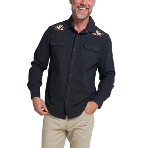 Man smiling wearing the black Orange Blossoms Crosscut Deluxe Longsleeve with embroidered floral shoulder detail, front view -- The Simple Man