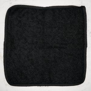 Soft black terry side of dual-sided face and body washcloth