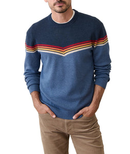 Model wearing Dean Crew Sweater navy with red and gold chevron stripe detail – organic cotton and recycled poly knit