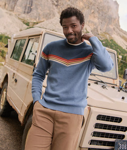 Man wearing Dean Crew Sweater navy with retro chevron stripes standing by vintage SUV – The Simple Man Omaha