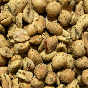 Roasted peanuts flecked with green dill pickle seasoning, close-up detail