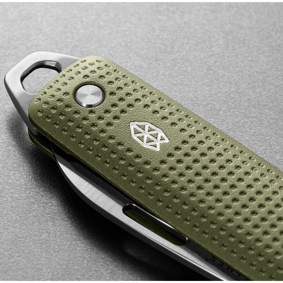 The James Brand Elko knife Grove colorway close-up — machined aluminum handle dot texture and stainless logo detail