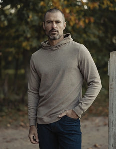Outdoor lifestyle photo of Puremeso Essential Hoodie in taupe – durable men’s hoodie worn in cool weather, styled with jeans, sold at The Simple Man.