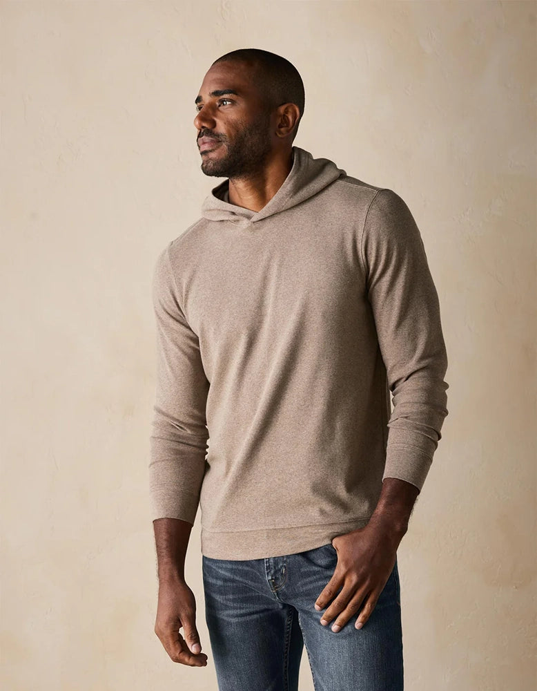 Side front view of Puremeso taupe hoodie on male model – modern, drawcord-free hoodie made with soft Puremeso fabric from The Normal Brand.
