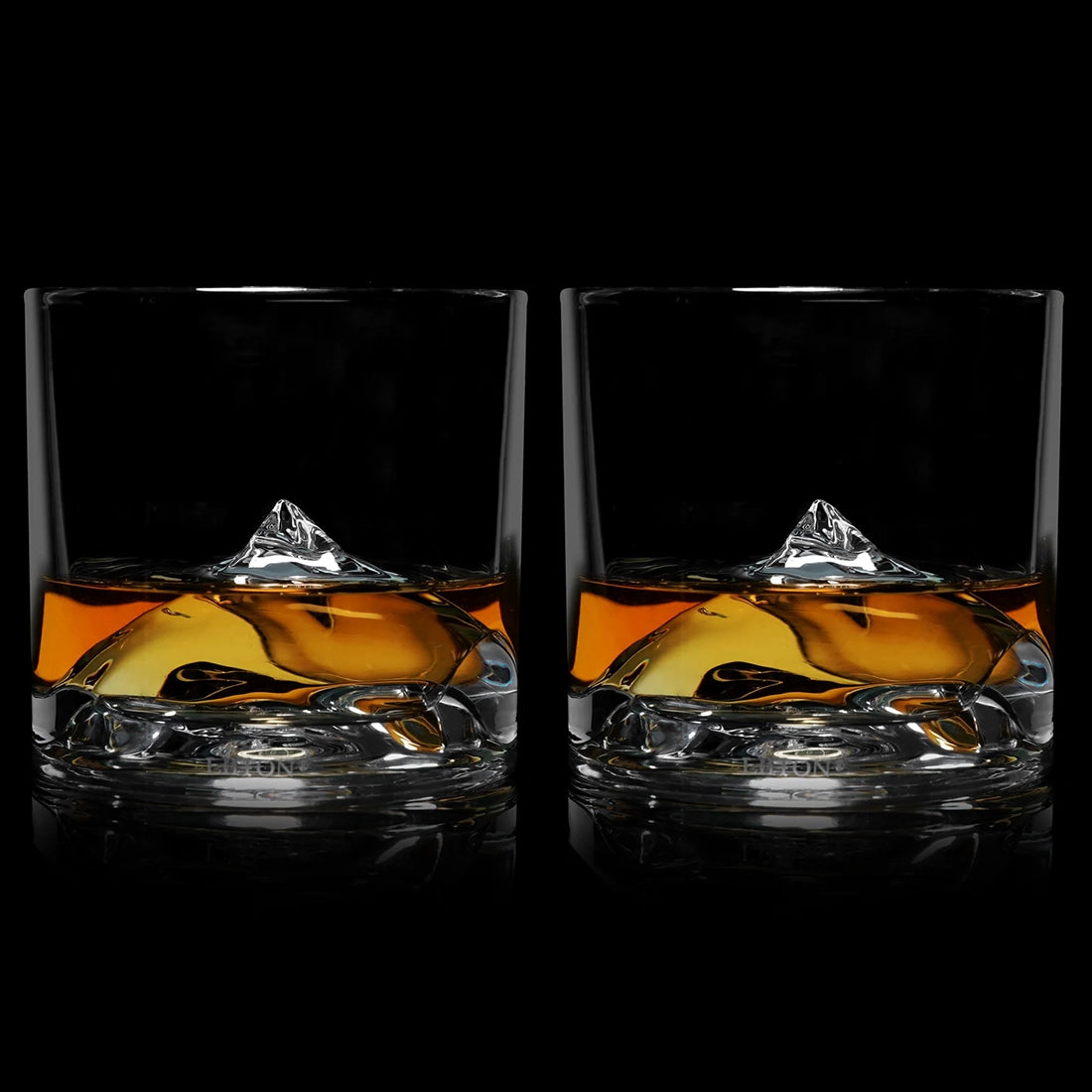 Set of two LIITON Everest Crystal Whiskey Glasses with whiskey poured over the sculpted mountain base – The Simple Man barware.