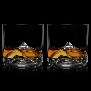 Set of two LIITON Everest Crystal Whiskey Glasses with whiskey poured over the sculpted mountain base – The Simple Man barware.