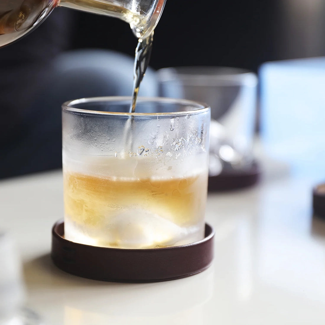 Whiskey being poured into a chilled LIITON Everest Crystal Glass, showcasing the fast-cooling design – lifestyle image from The Simple Man.