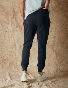 Model wearing The Normal Brand Everyday Jogger in Navy, rear view