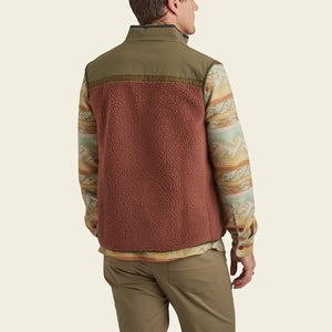 model wearing Howler Brothers Crozet Fleece vest in cherrywood / Olive, rear view