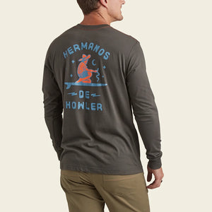 model Wearing Howler Bros. long sleeve t-shirt with ocean offerings graphic in antique black, rear view