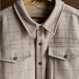 Close-up of Fielding Shirt Jacket Stonecross collar and button-flap chest pockets on hanger, wool-blend windowpane detail - The Simple Man