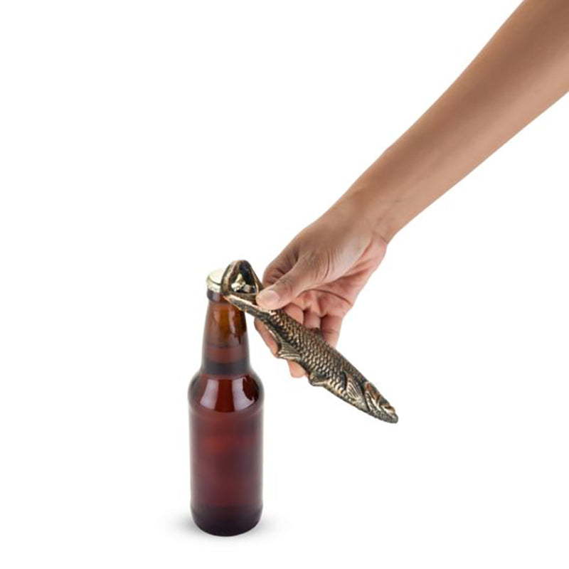 Cast Iron Fish Bottle opener without packaging shown opening a bottle