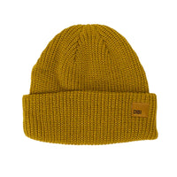 Yellow knit beanie with a brown patch on a white background