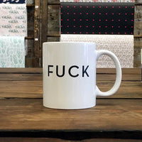 white coffee mug with the word FUCK in Black