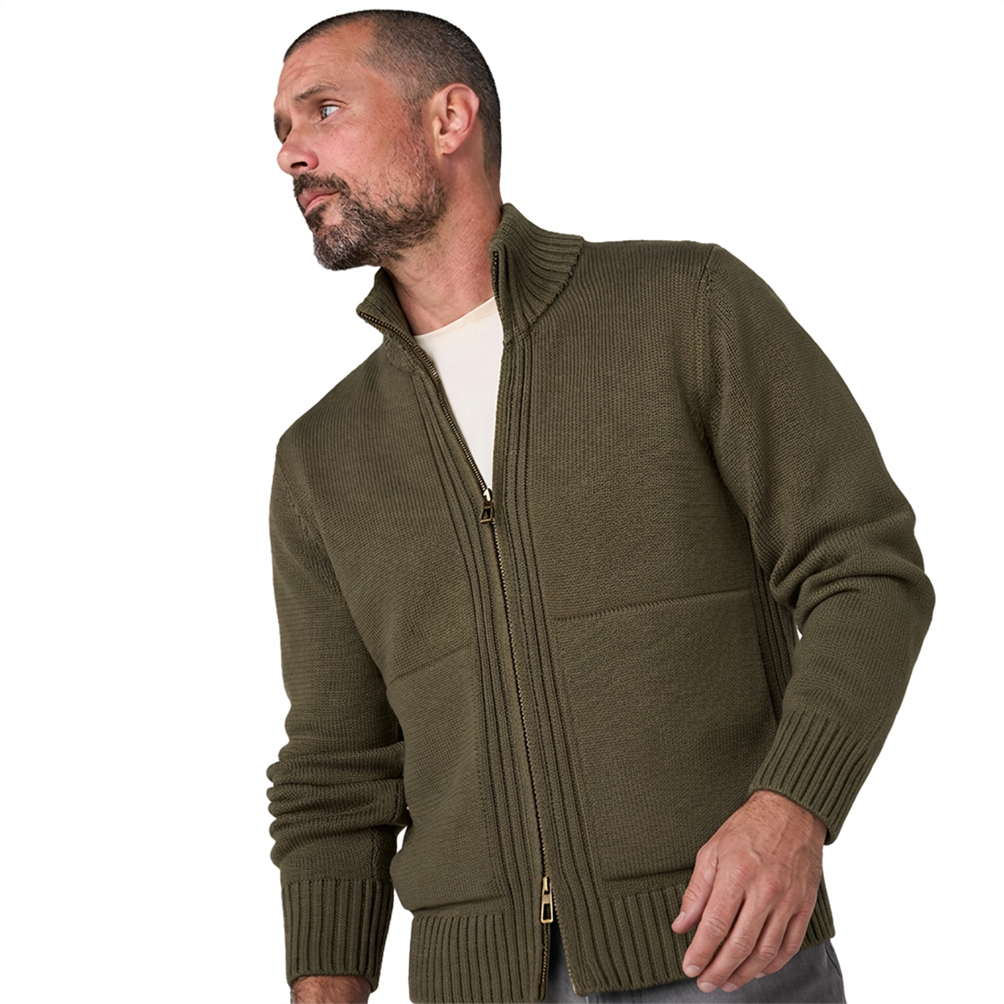 Man wearing the olive full zip sweater open over a cream tee, stand collar up and ribbed cuffs