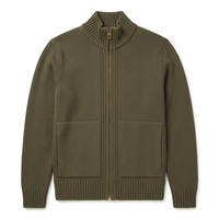 Flat lay of an olive full zip knit sweater with ribbed stand collar, brass zipper and two front pockets