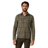 Man wearing an olive green plaid flannel shirt with hands in pockets, styled with brown pants - Generation Long Sleeve Shirt in Basil, front view - The Simple Man