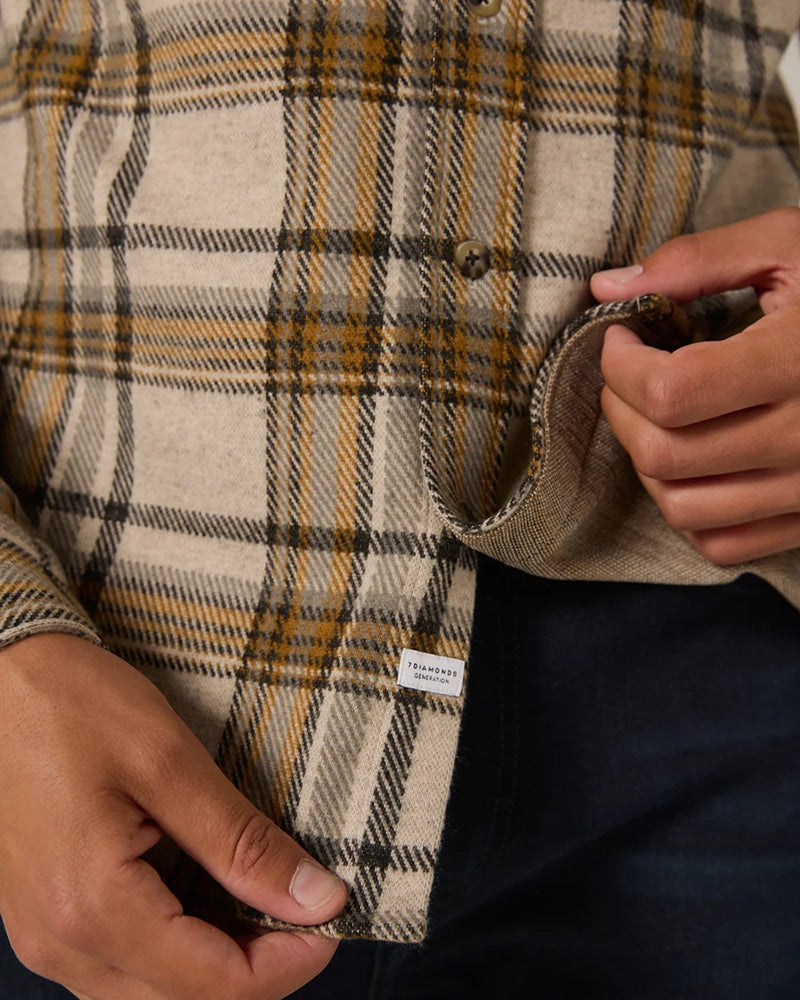 Close-up of Generation™ Plaid Shirt hem and fabric texture, showing faux-horn button detail and 7DIAMONDS Generation label – premium men's shirting.