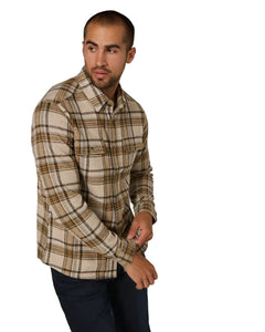 Man wearing Generation™ Plaid Shirt in beige and mustard plaid, adjusting sleeve cuff – 4-way stretch men's shirt from The Simple Man.