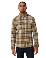 Man modeling Generation™ Plaid Shirt, standing with arms relaxed, featuring button-front and chest pockets – durable and stylish shirt for men.