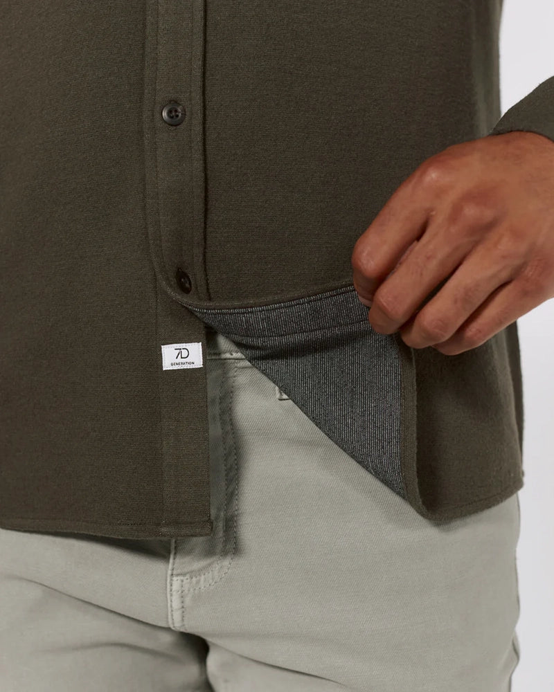 Close-up of Generation Solid Shirt hem and interior fabric texture in olive green