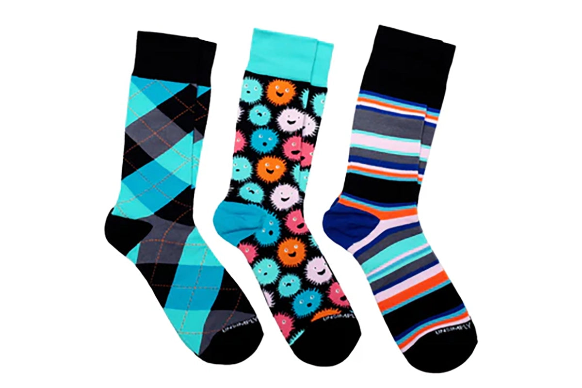 Three-pair Puffer Fish men’s sock set featuring teal argyle, colorful puffer fish pattern, and striped crew socks from The Simple Man