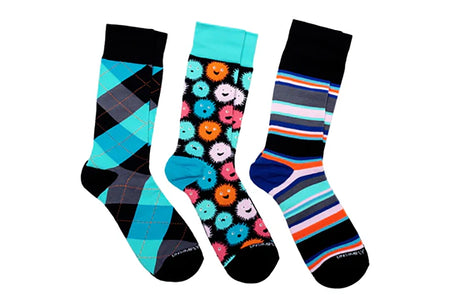Three-pair Puffer Fish men’s sock set featuring teal argyle, colorful puffer fish pattern, and striped crew socks from The Simple Man