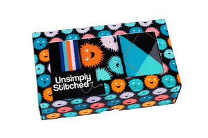 Puffer Fish sock gift box by UnsimpIy Stitched showing three colorful men’s crew socks inside patterned packaging at The Simple Man