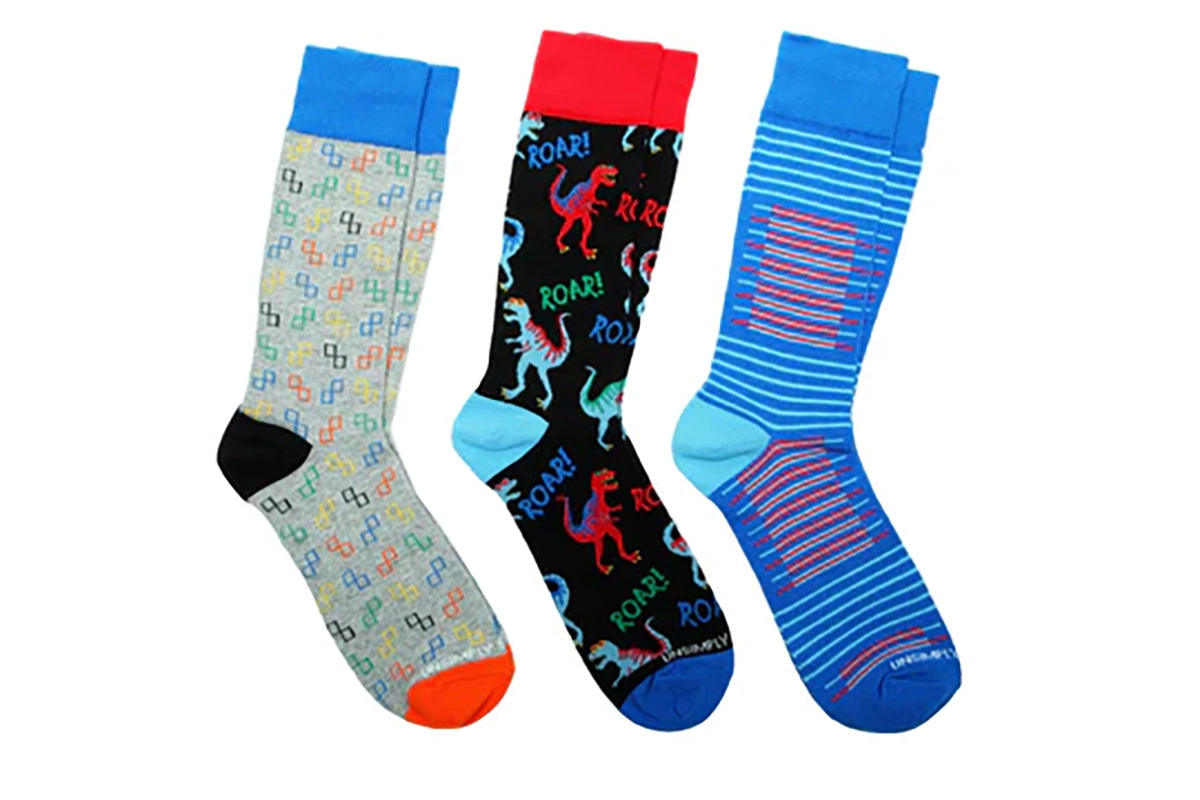 Three-pair T-Rex Roar men’s crew socks in bright multi-color patterns, including dinosaurs, stripes, and geometric prints, from The Simple Man in Omaha.