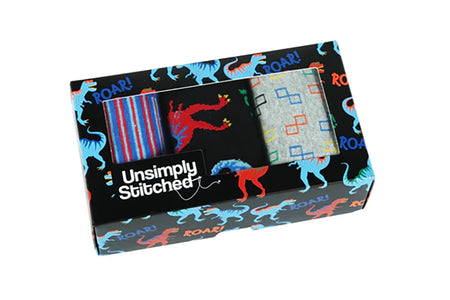 T-Rex Roar men’s sock gift box by UnsimpIy Stitched, featuring three colorful pairs displayed in dinosaur-themed packaging from The Simple Man.