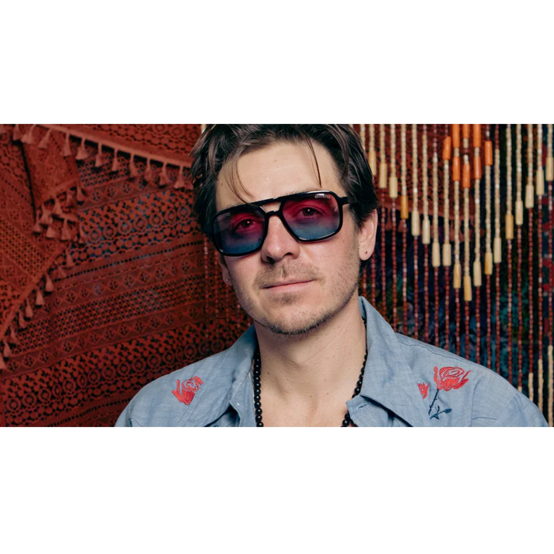 Man wearing Grateful Dead Stealie polarized sunglasses with gradient lenses