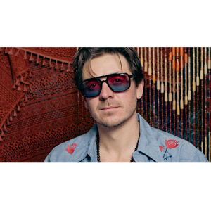 Man wearing Grateful Dead Stealie polarized sunglasses with gradient lenses