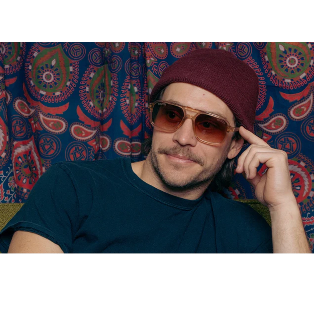 Man wearing Grateful Dead Bears brown polarized sunglasses with desert translucent frame