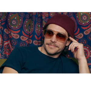 Man wearing Grateful Dead Bears brown polarized sunglasses with desert translucent frame